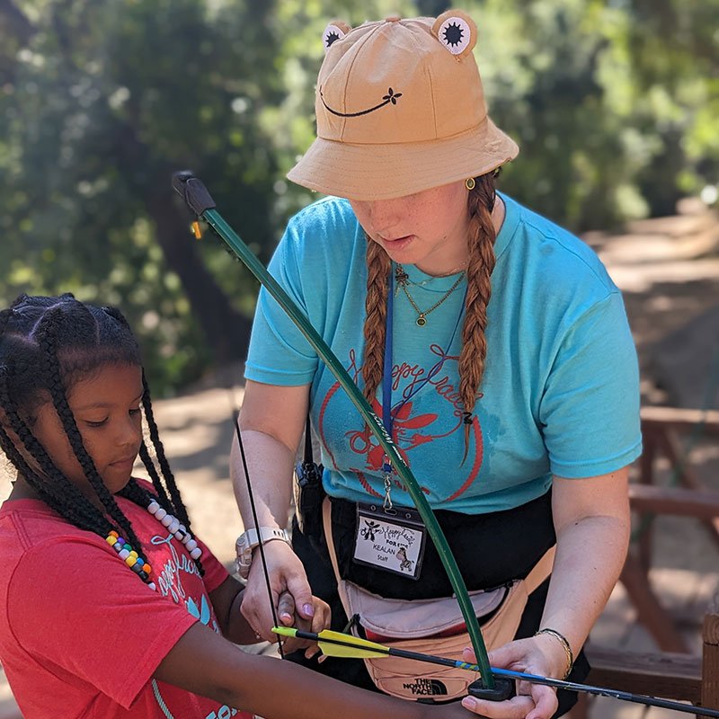 girl learning archery